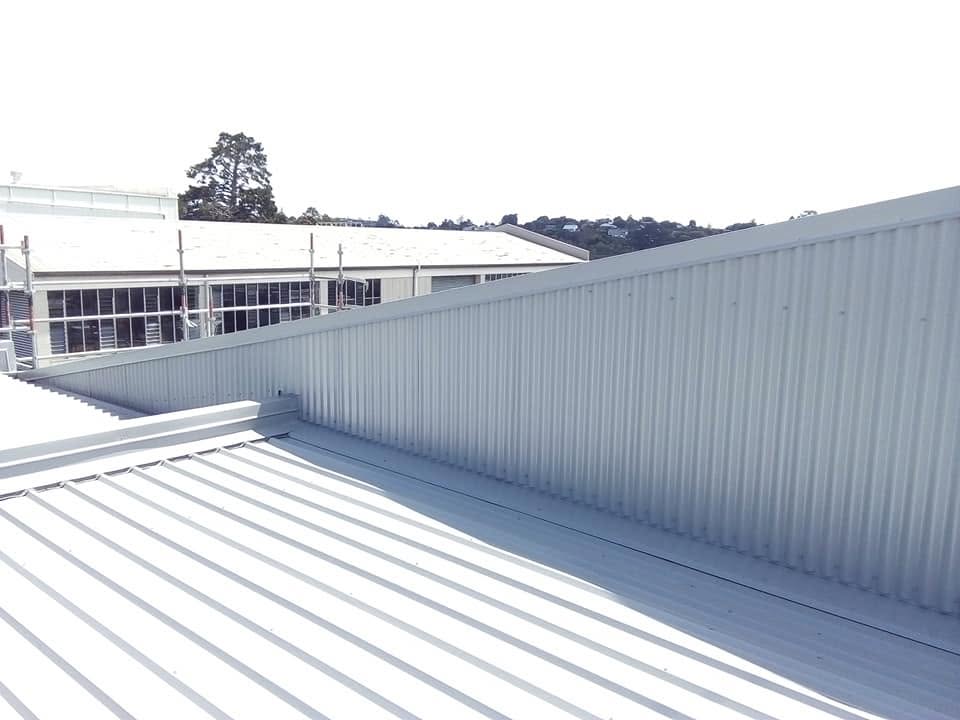 Light grey long-run roofing on a commercial building with clean ribbed sheets