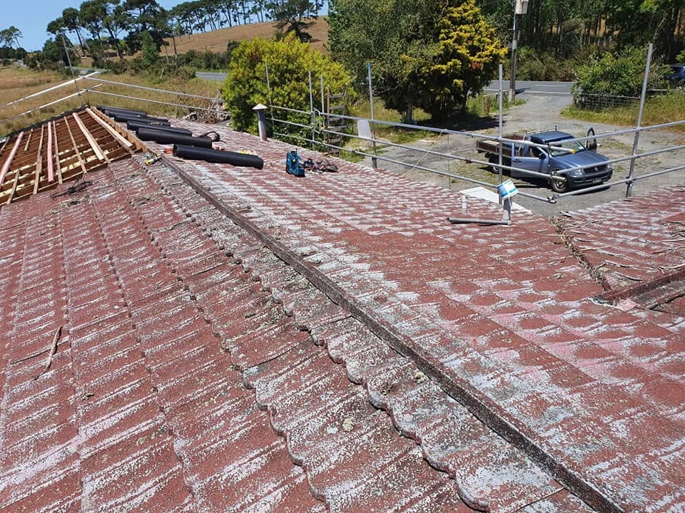 Old red tile roof being stripped back for replacement