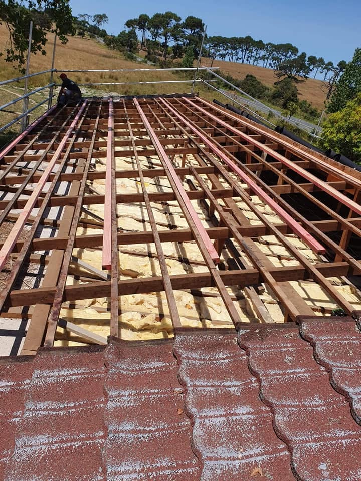 Tile strip and fresh timber battens across a large roof