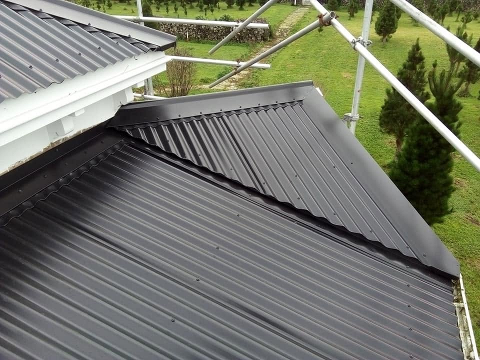 Dark corrugated roof ridge shot from the scaffold